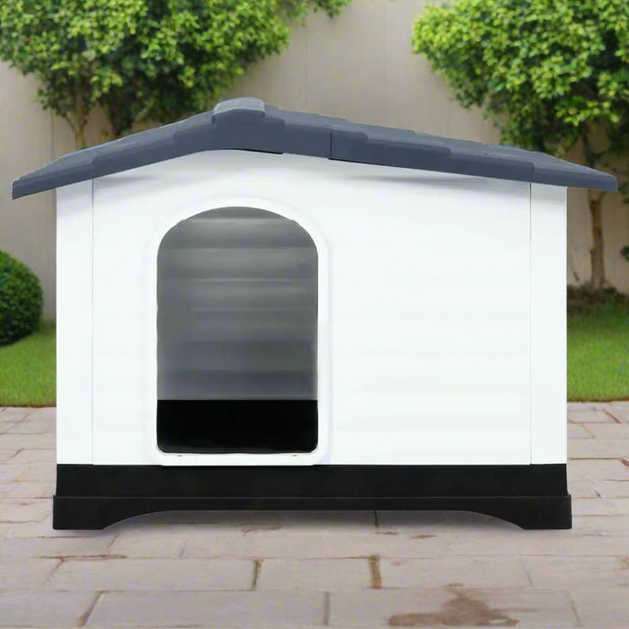Grey, white, and black outdoor dog house with ventilation and raised floor on patio