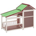 Outdoor dog kennel made of solid pine wood with a green sloped roof and large entrance