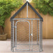 Galvanized steel outdoor dog kennel with mesh roof in a fenced backyard