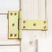 Close-up of a yellow metal T-hinge attached to light natural wooden doors