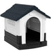 Outdoor plastic dog kennel with raised base, slanted roof, and ventilated windows
