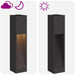 Black outdoor solar LED pathway lights with warm glow at night and off during day