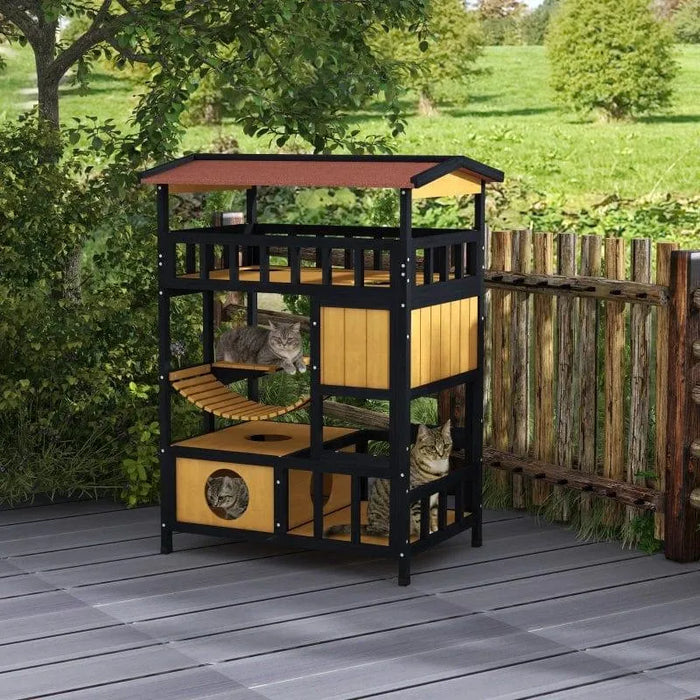 Outdoor wooden cat house with four levels, suspension bridge, and balcony, three cats inside