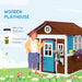Colorful wooden garden playhouse with planter boxes and serving stations outdoors
