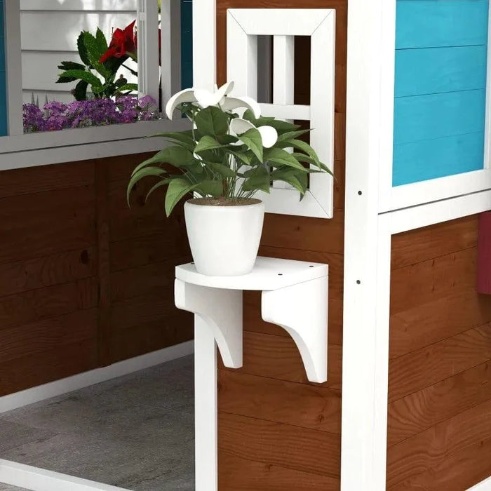 Outdoor wooden garden playhouse with planter box and white potted plant