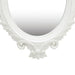 Decorative white mirror with intricate detailing on a white background