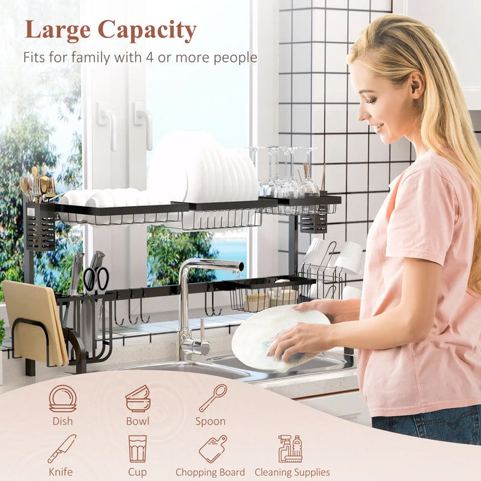 Woman washing dishes in a kitchen with a large capacity dish rack.