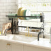 Kitchen dish rack with plates, utensils, and a cutting board above a sink.