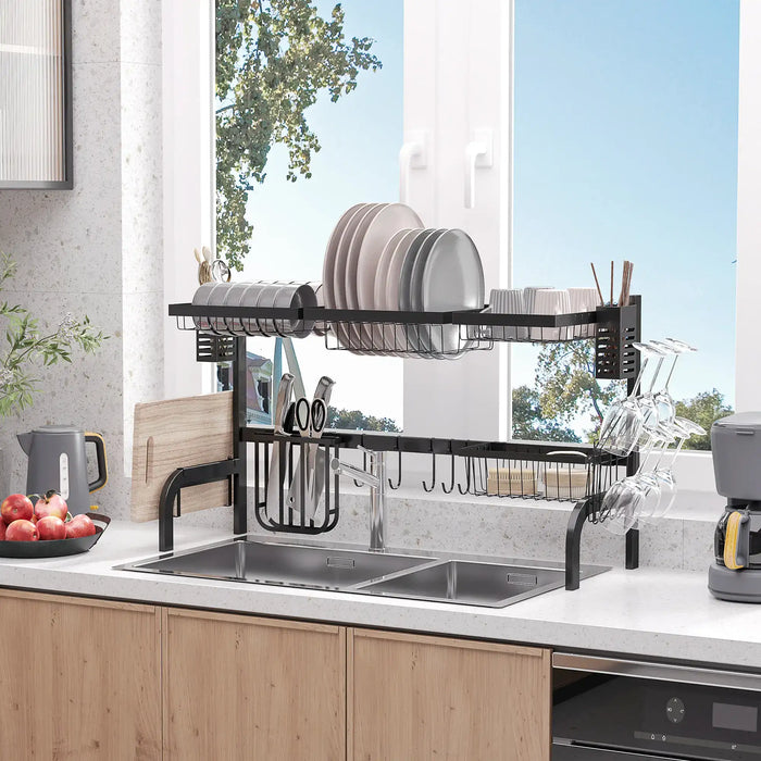 Kitchen dish rack with cutlery holder on a kitchen counter with a window view.