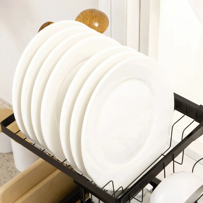 Stack of white plates on a black dish rack in a kitchen setting