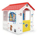 PAW Patrol Adventure Bay playhouse with cartoon pups, white walls, red roof, and yellow door