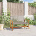 Outdoor grey PE rattan garden bench with wooden armrests on stone patio against wooden fence