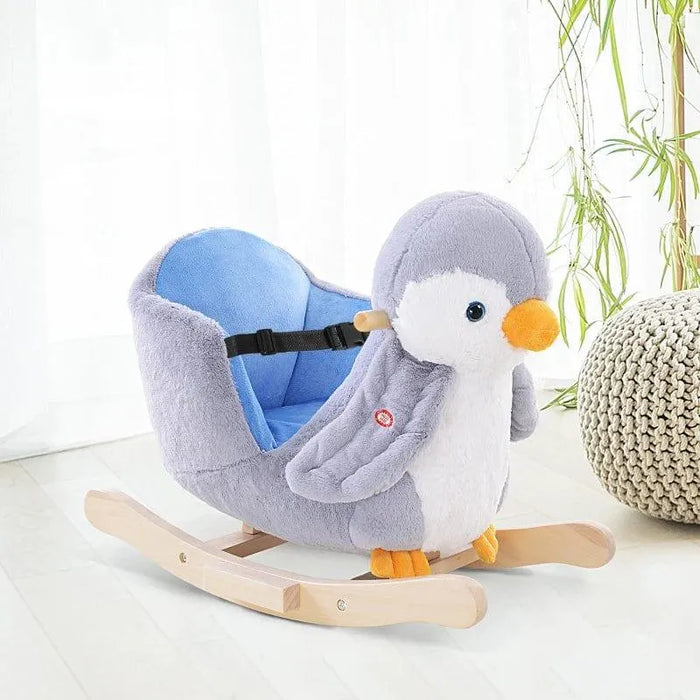 Plush penguin rocking horse with seatbelt and wooden rockers in a bright room
