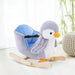 Plush penguin rocking horse with seatbelt and wooden rockers in a bright room