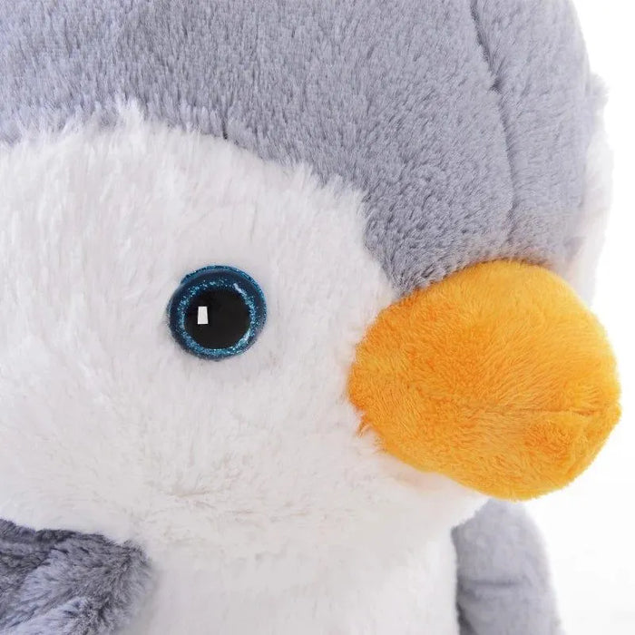 Close up of plush penguin rocking horse with soft grey and white fur and yellow beak