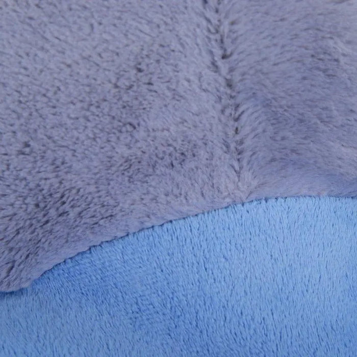 Close-up of soft plush grey and blue fabric from a stuffed toy or padded seat.