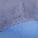Close-up of soft plush grey and blue fabric from a stuffed toy or padded seat.