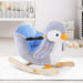 Penguin plush rocking horse with wooden frame and seat in a modern nursery