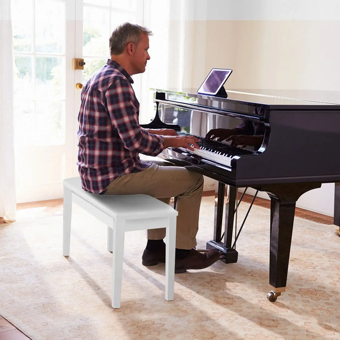 Man playing a digital piano in a bright room with large windows.