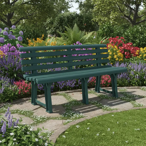 Green weather-resistant plastic garden bench on stone patio surrounded by colorful flowers