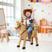 Child in cowboy outfit riding plush standing ride-on horse toy in colorful playroom