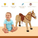 Smiling baby next to plush standing ride-on horse toy with saddle, suitable for kids aged 3 and up