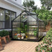 Polycarbonate greenhouse with grey aluminium frame and sliding door on garden patio