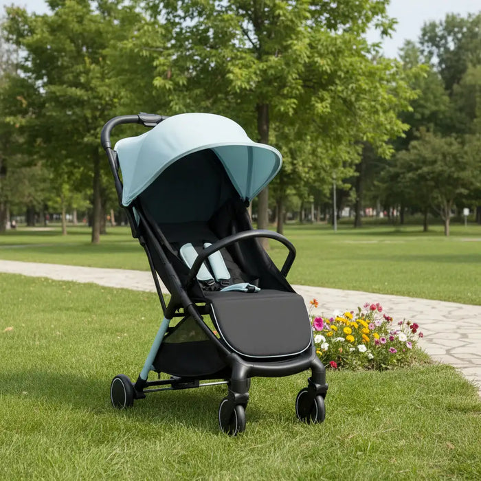 Black stroller with a light blue canopy in a park setting
