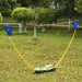 Portable badminton set with net and suitcase kit set up on green grass outdoors