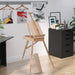 Portable folding wooden easel with adjustable height in beech wood in a modern artist studio