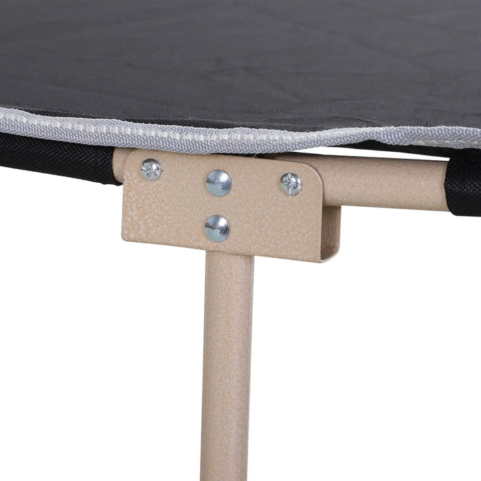Close-up of portable military camping cot with tan steel frame and black fabric