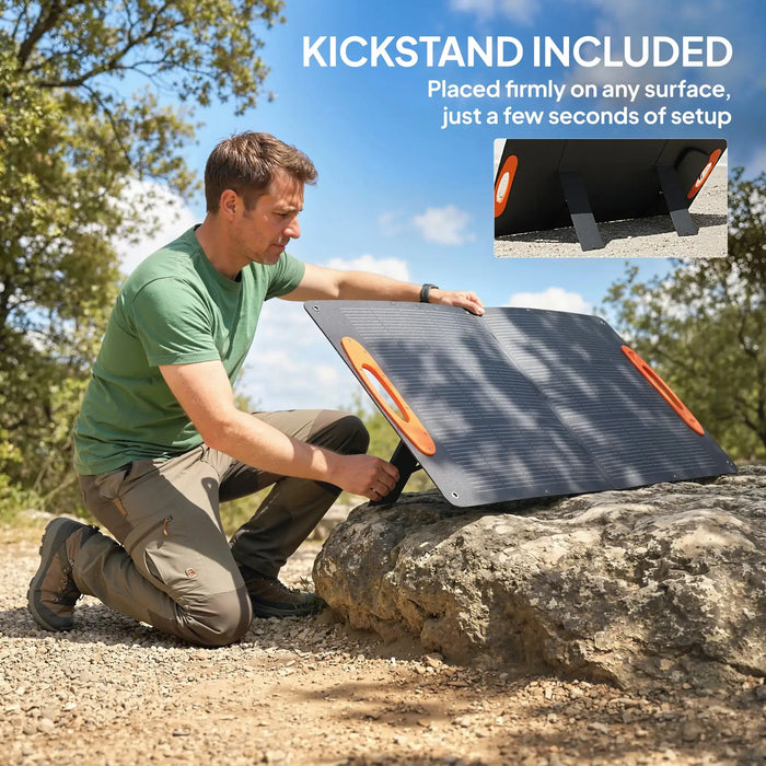 Man setting up portable solar panel with built-in kickstand on rocky outdoor terrain