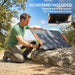 Man setting up portable solar panel with built-in kickstand on rocky outdoor terrain