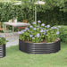 Round powder-coated steel raised garden bed with purple flowers in a backyard patio setting