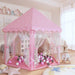 Princess-themed pink play tent and ball pit with soft play balls in a cozy child's room