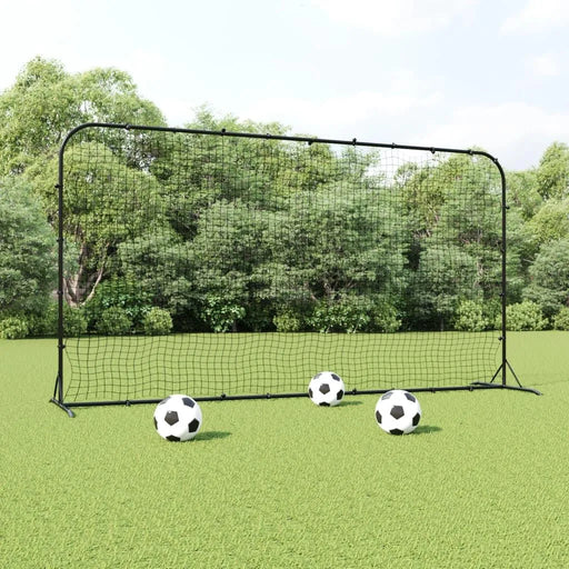 Professional football rebounder net with three soccer balls on grass field outdoors
