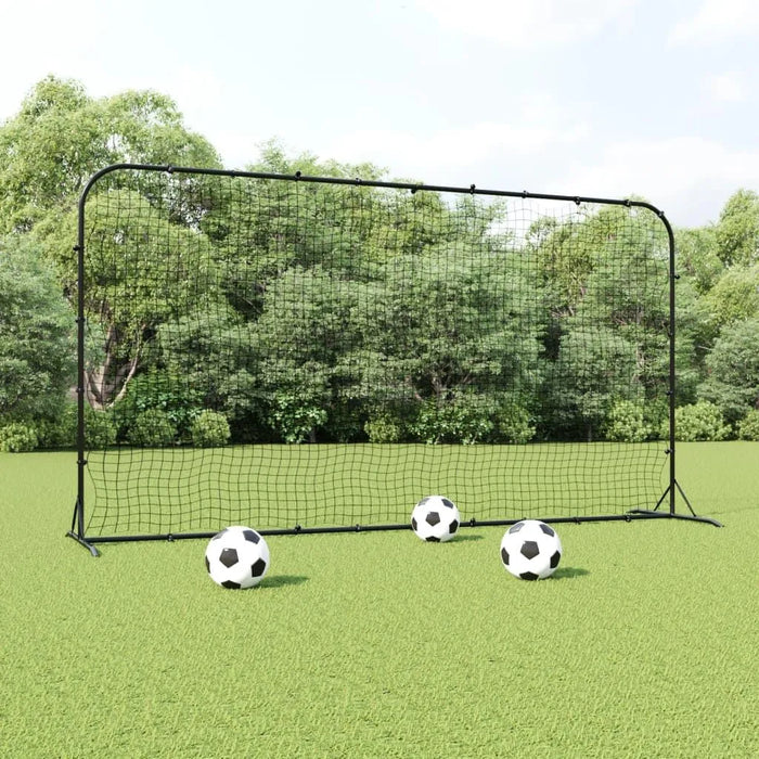 Professional football rebounder net with three soccer balls on grass field outdoors