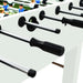 Close-up of white foosball table with black handles and player figures on green pitch