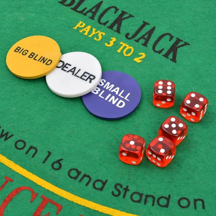 Poker and blackjack chips and dice on green casino table felt