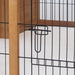 Black metal wire pet gate latch with wooden frame in indoor setting