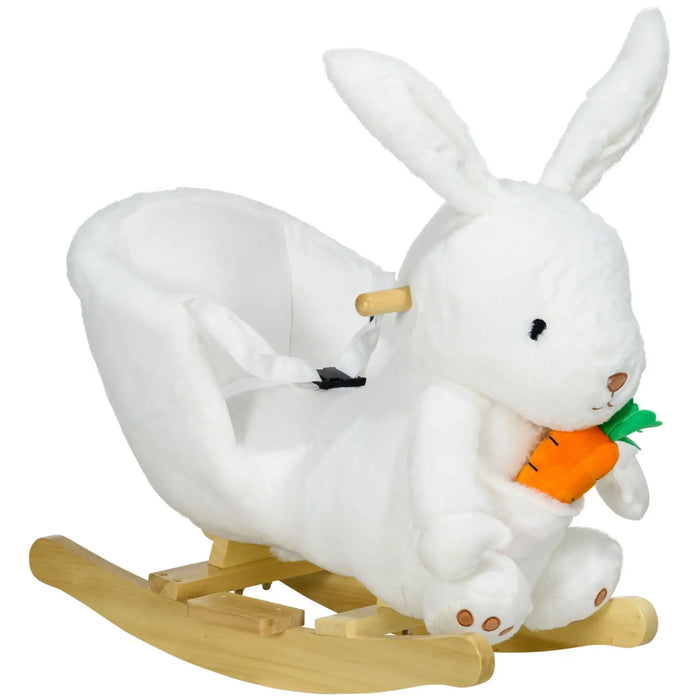 White rabbit plush toy on a wooden rocking base with a carrot.