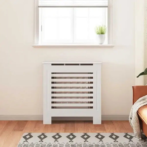 White radiator cover in a room with wooden flooring and a window.