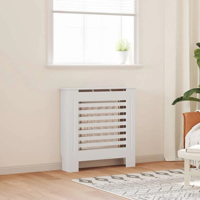 White radiator in a room with a window and plant
