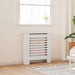 White radiator in a room with a window and plant