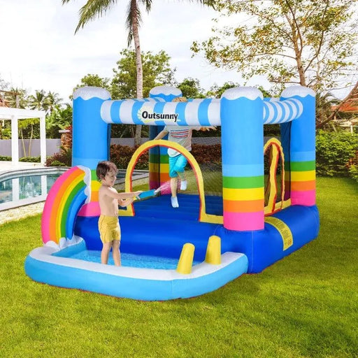 Kids playing on a rainbow inflatable bouncy castle trampoline with pool by Outsunny outdoors