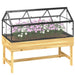 Raised garden bed with natural wood frame and clear polycarbonate roof housing pink and white flowers