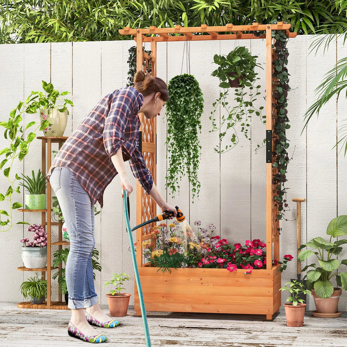 Woman watering flowers in a wooden raised garden bed with trellis and hanging plants, outdoor patio gardening