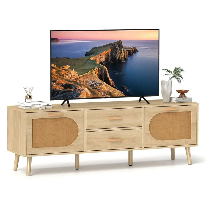 Natural wood rattan TV stand with drawers and cabinets holding a 65-inch TV, styled with books and a plant