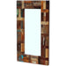 Rectangular mirror with a wooden frame made of various wood pieces on a white background