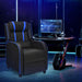 Gaming chair with blue accents in a dark room with gaming setup